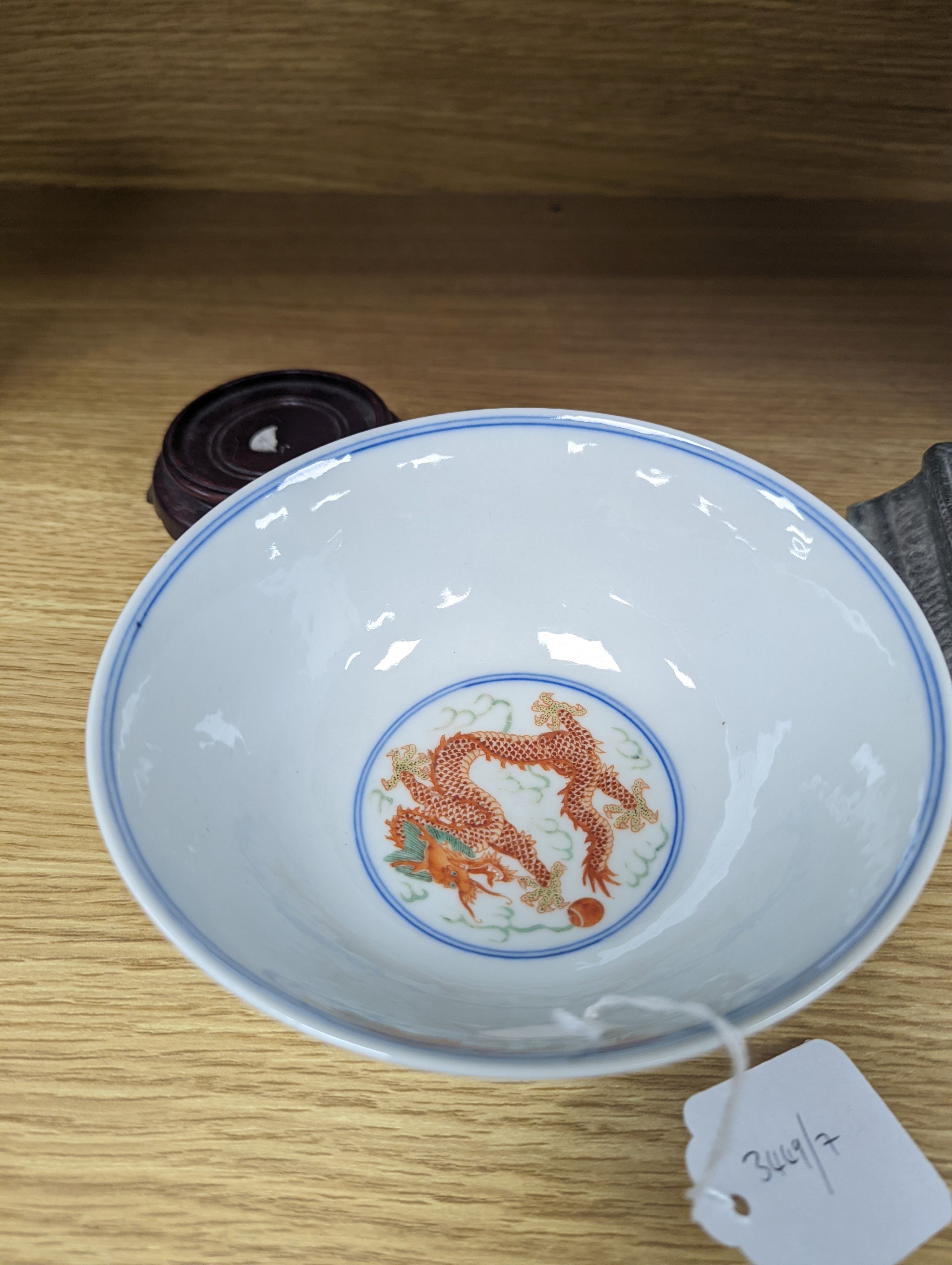A Wucai bowl, dragon and flamingo pearl decoration, Jiaqing mark, on wood stand. 16cm diameter
